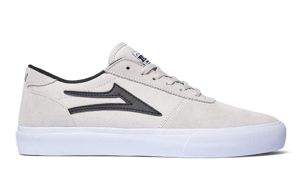 White and black suede Manchester skate shoes with vulcanized construction.