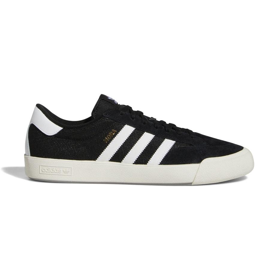 Adidas Nora skateboarding shoe in Core Black with white stripes, featuring a premium suede upper and rubber toe bumper.