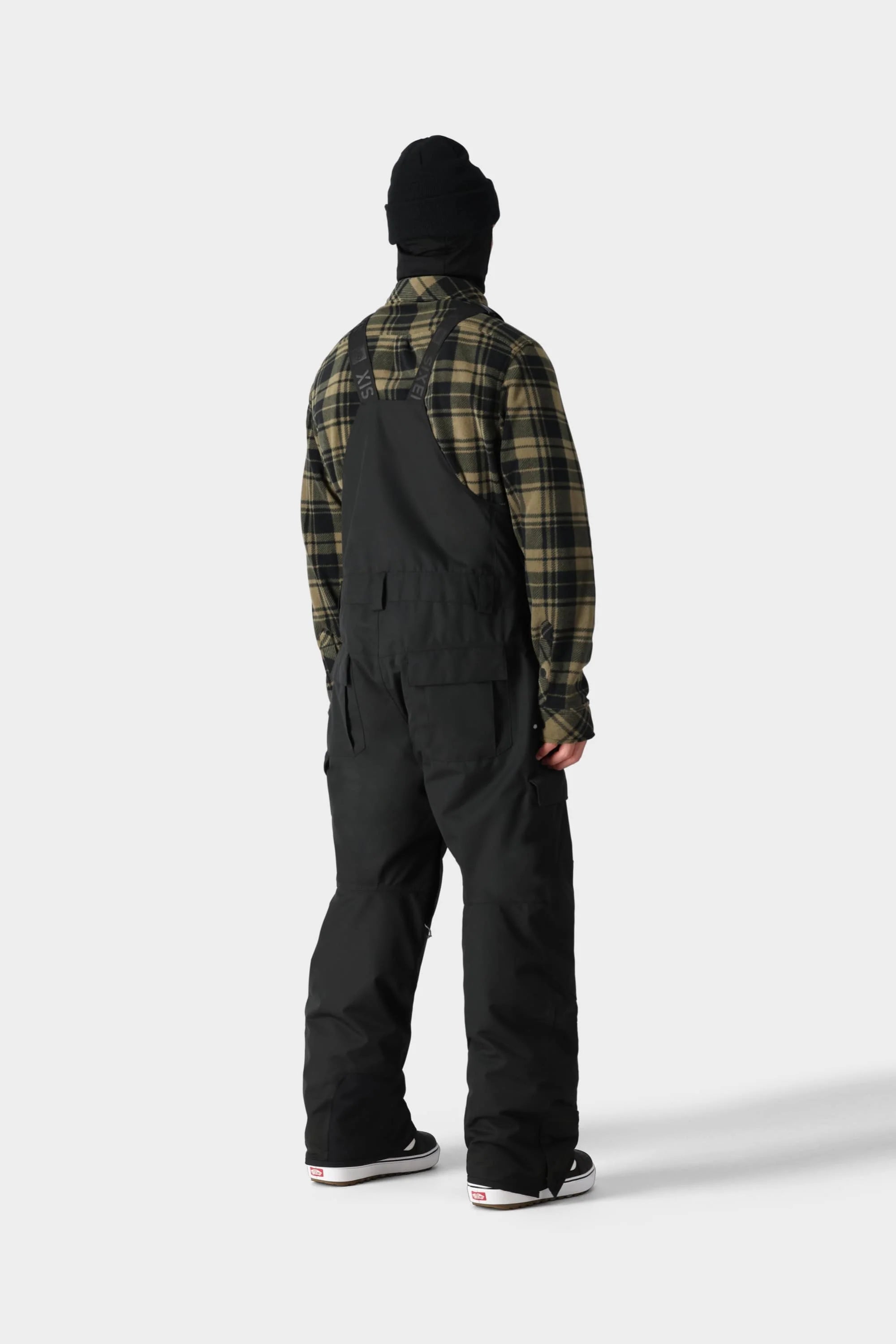 Man wearing Hot Lap Insulated BIB in black, ideal for colder climates with multiple pockets and adjustable straps.