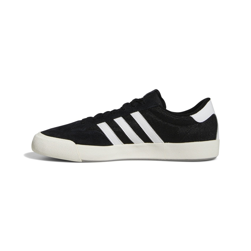 Adidas Nora skateboarding shoe in Core Black, Cloud White, Grey Two, featuring premium suede, cushioned midsole, and rubber outsole.