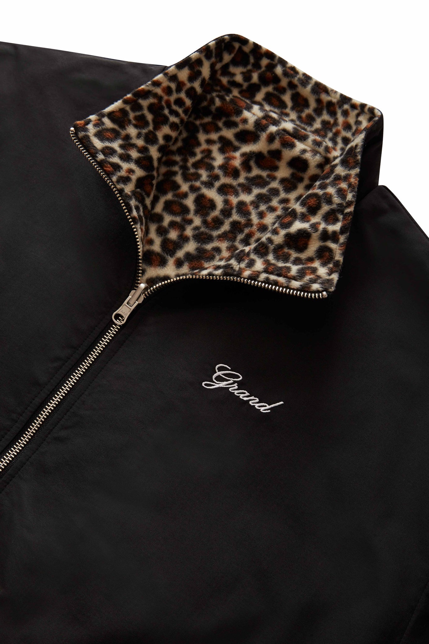 Grand Collection reversible leopard jacket with micro fleece print and Taslan nylon sides, embroidered logo, YKK zipper, and elastic cuffs.